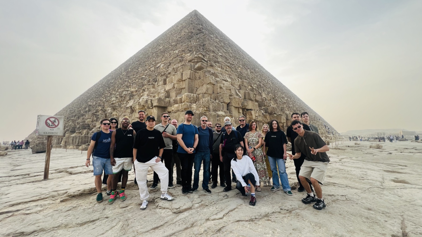 Wayfinder group gathered beside a pyramid on the Giza Plateau