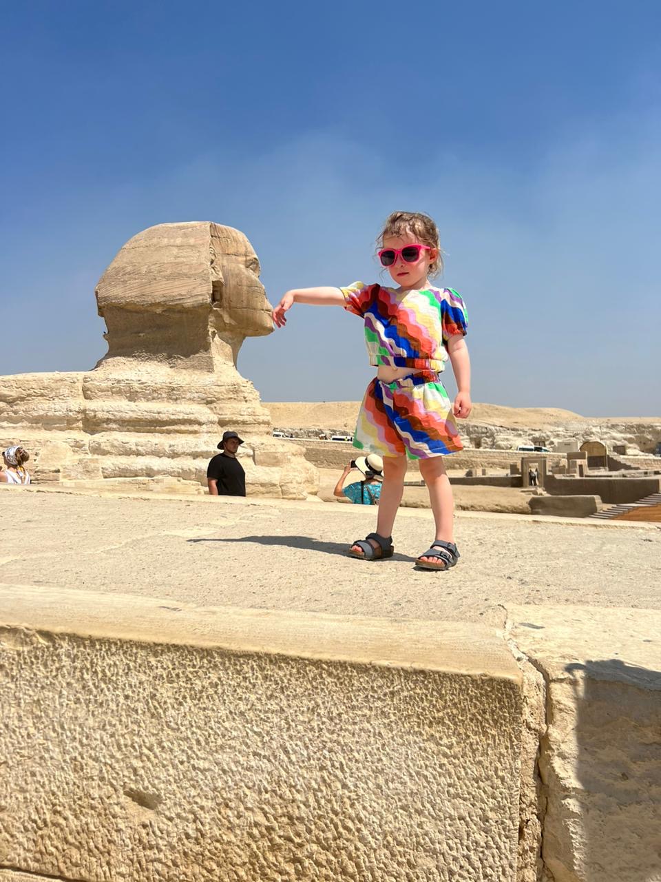 Young guest enjoying a playful photograph beside the Great Sphinx