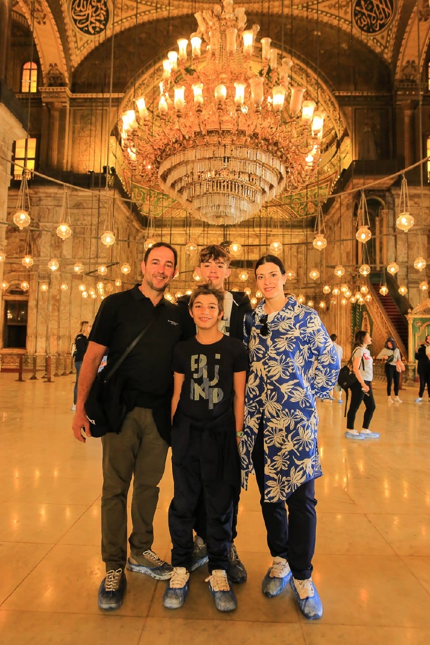 Wayfinder family beneath the chandelier inside the Muhammad Ali Mosque